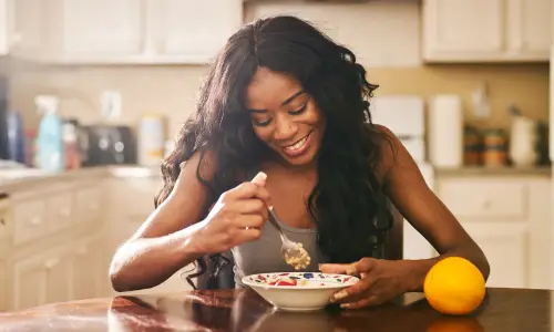 woman eating yogurt fruit
