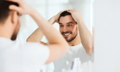 man smiling in mirror