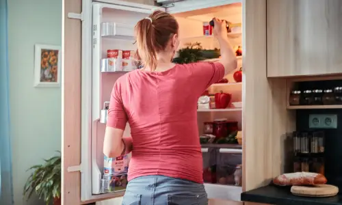 woman looking in fridge