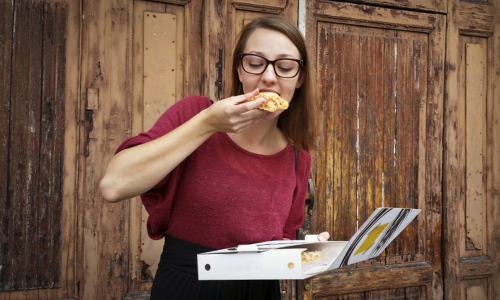 woman eating pizza